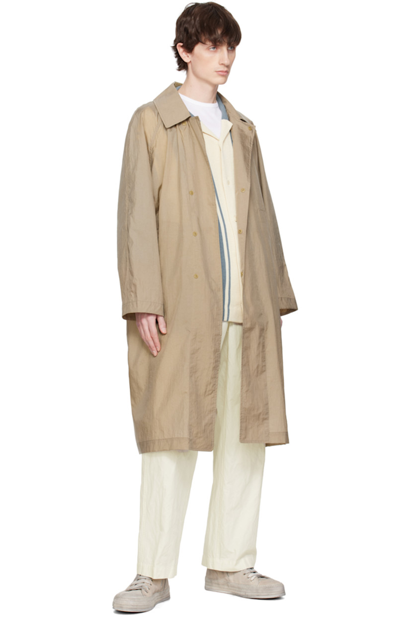 Nylon taffeta coat. Packable, lightweight, and waterproof.

· Spread collar
· Concealed press-stud closure
· Welt pockets
· Raglan sleeves
· Central vent at back hem
· Patch pocket at interior 
· Unlined

Supplier color: Khaki