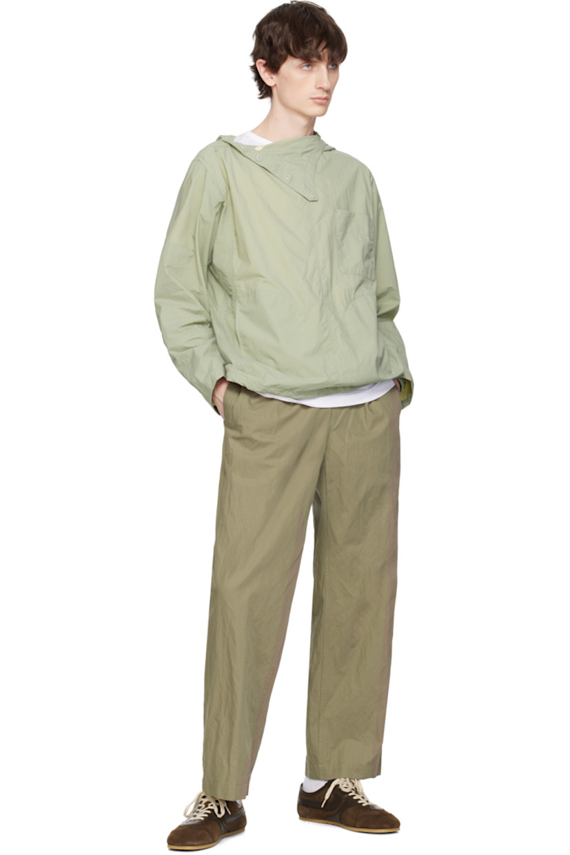 Nylon taffeta jacket. 

· Bungee-style drawstring at hood and hem
· Button fastening at funnel neck extends to shoulder
· Patch pocket and welt pockets
· Concealed elasticized cuffs
· Unlined 

Supplier color: Olive