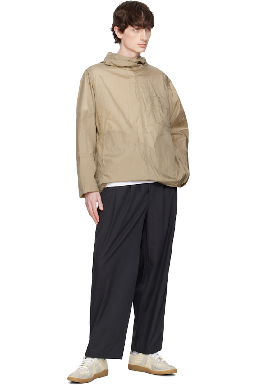 Nylon taffeta jacket. 

· Bungee-style drawstring at hood and hem
· Button fastening at funnel neck extends to shoulder
· Patch pocket and welt pockets
· Concealed elasticized cuffs
· Unlined 

Supplier color: Khaki