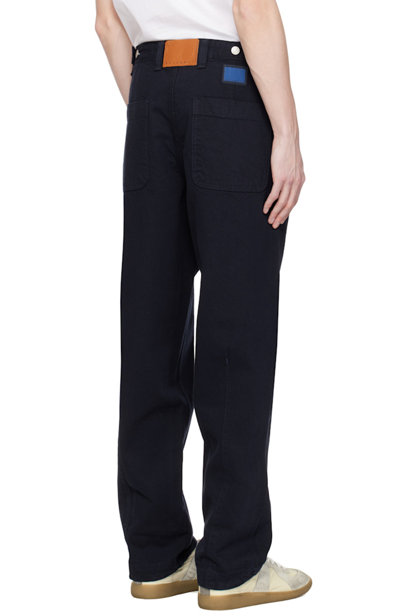 Non-stretch denim jeans. 

· Belt loops
· Four-pocket styling
· Button fly
· Darts at legs
· Adjustable button tabs at back waistband
· Leather logo patch and textile logo patch at back
· Logo-engraved bronze- and silver-tone hardware

Supplier color: Navy