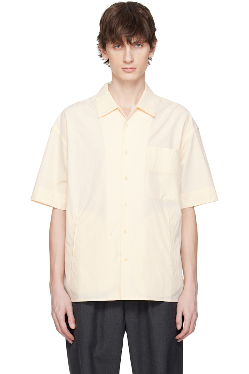Cotton- and polyester-blend poplin shirt.

· Spread collar
· Button closure 
· Patch pocket and welt pockets
· Shirttail hem 
· Vented side seams
· Gathering at shoulders

Supplier color: Ivory