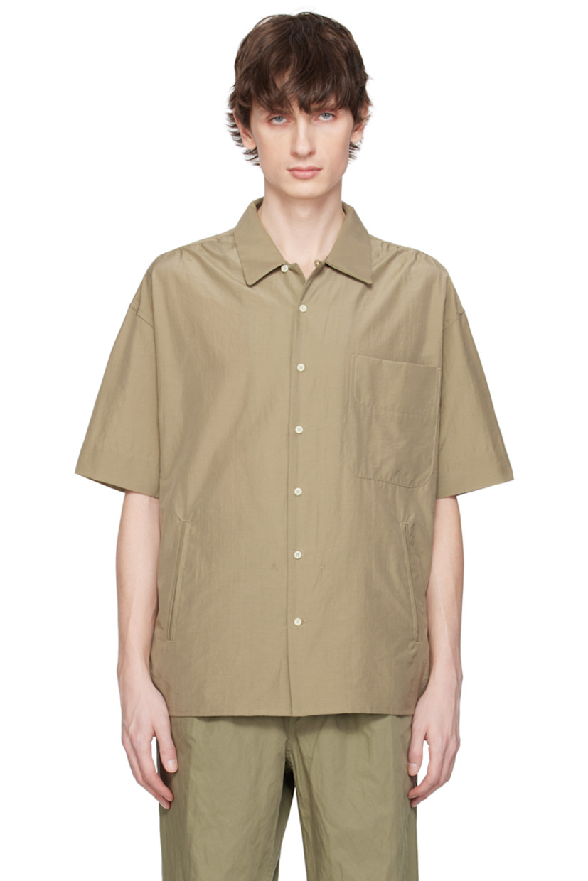 Cotton- and polyester-blend poplin shirt.

· Spread collar
· Button closure 
· Patch pocket and welt pockets
· Shirttail hem 
· Vented side seams
· Gathering at shoulders

Supplier color: Olive