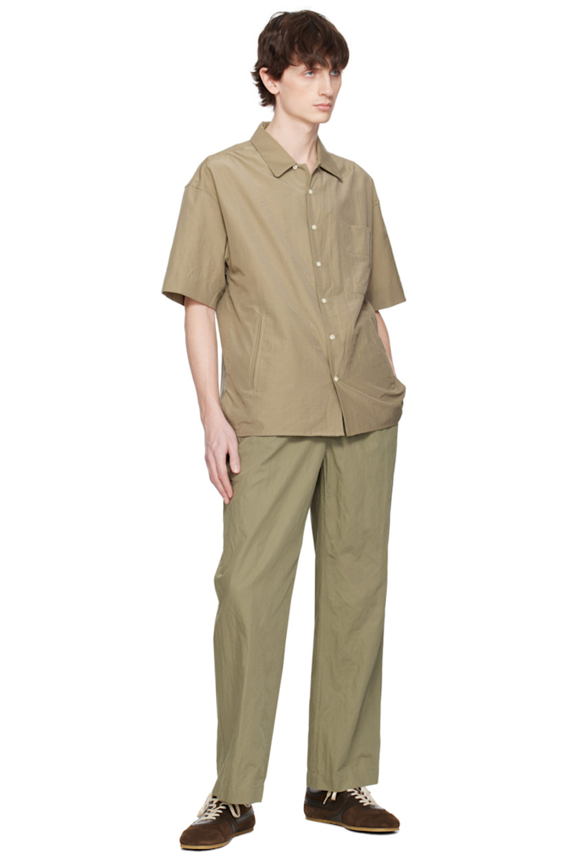 Cotton- and polyester-blend poplin shirt.

· Spread collar
· Button closure 
· Patch pocket and welt pockets
· Shirttail hem 
· Vented side seams
· Gathering at shoulders

Supplier color: Olive