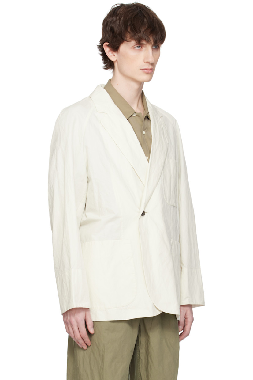 Garment-washed cotton-blend twill blazer. 

· Notched lapel
· Double-breasted button closure
· Patch pockets
· Raglan sleeves
· Central vent at back hem
· Partially lined
· Horn hardware

Supplier color: Ivory