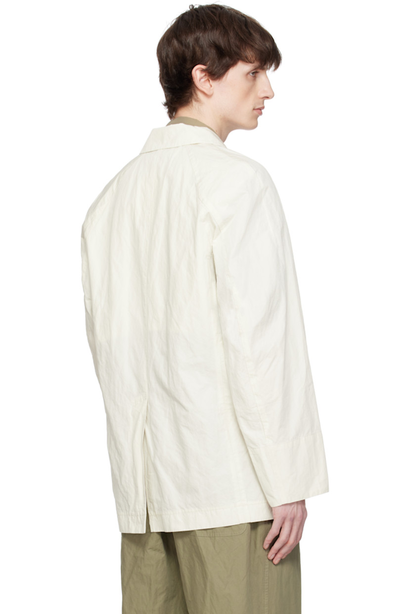 Garment-washed cotton-blend twill blazer. 

· Notched lapel
· Double-breasted button closure
· Patch pockets
· Raglan sleeves
· Central vent at back hem
· Partially lined
· Horn hardware

Supplier color: Ivory