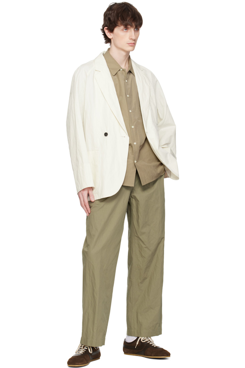 Garment-washed cotton-blend twill blazer. 

· Notched lapel
· Double-breasted button closure
· Patch pockets
· Raglan sleeves
· Central vent at back hem
· Partially lined
· Horn hardware

Supplier color: Ivory