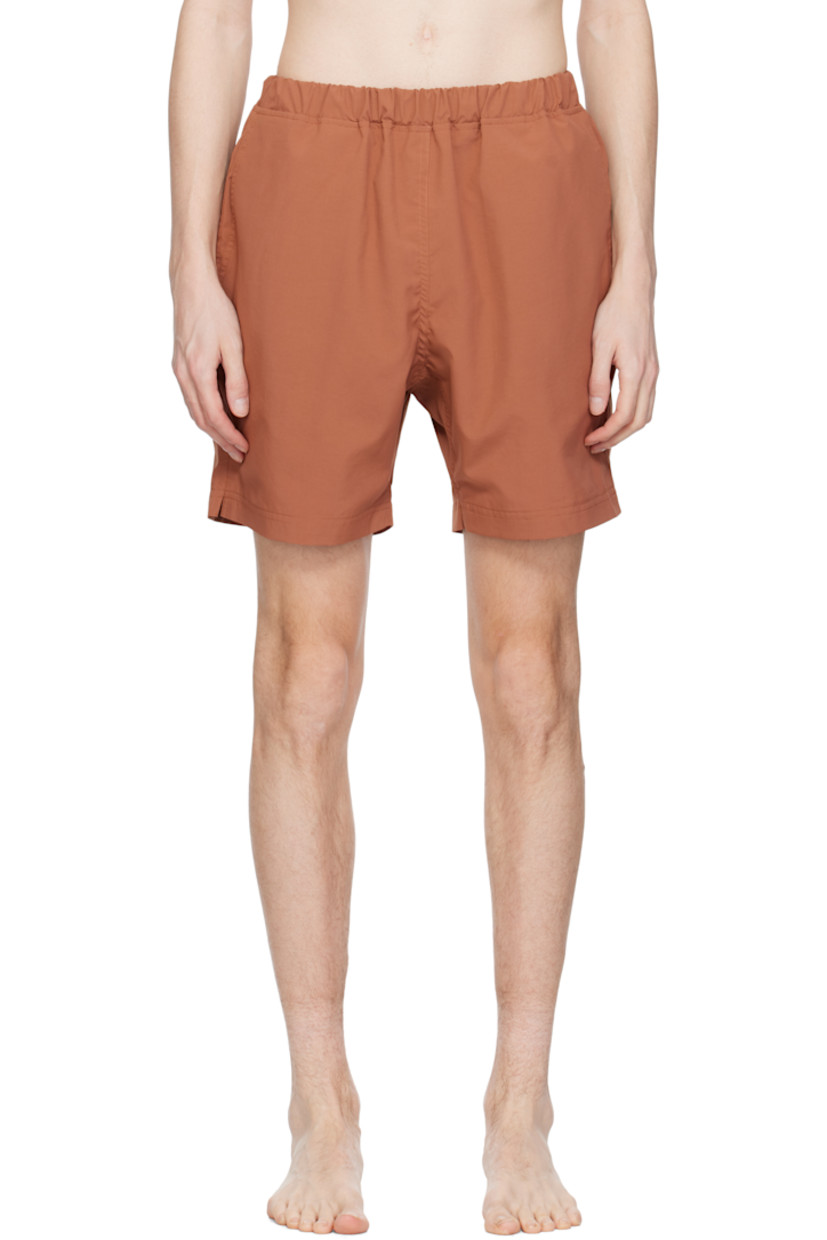 Taffeta swim shorts. 

· Concealed drawstring at elasticized waistband
· Three-pocket styling
· Logo patch at back waistband
· Partial mesh lining 

Supplier color: Brick