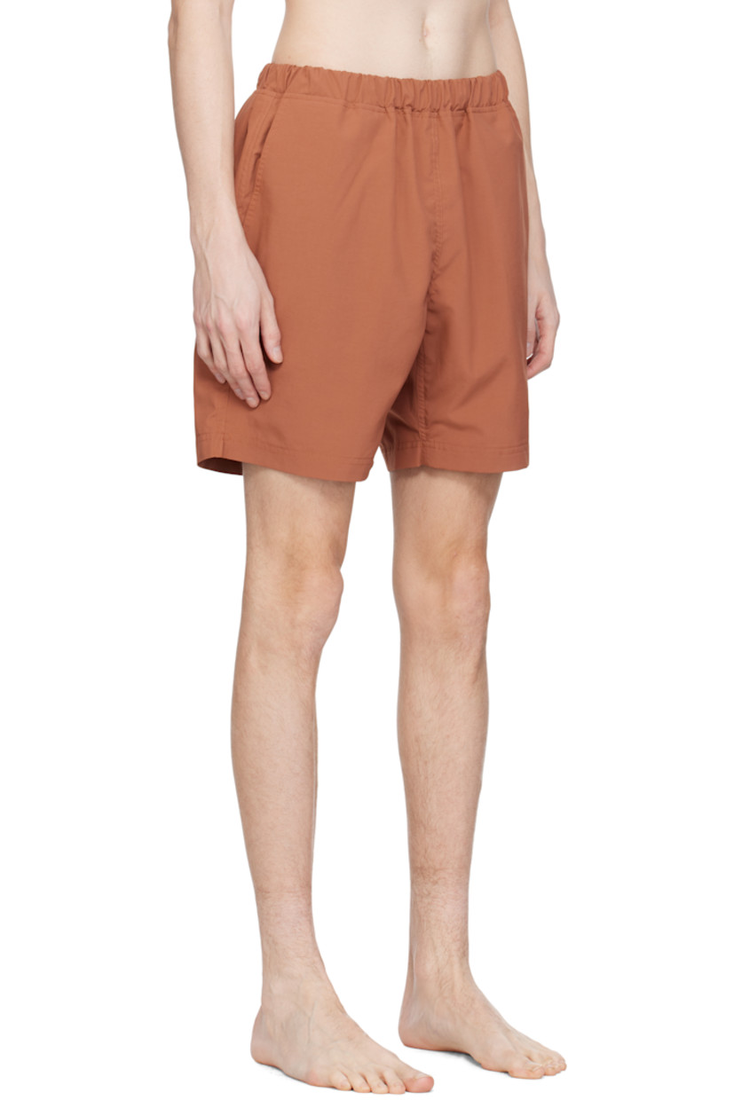 Taffeta swim shorts. 

· Concealed drawstring at elasticized waistband
· Three-pocket styling
· Logo patch at back waistband
· Partial mesh lining 

Supplier color: Brick