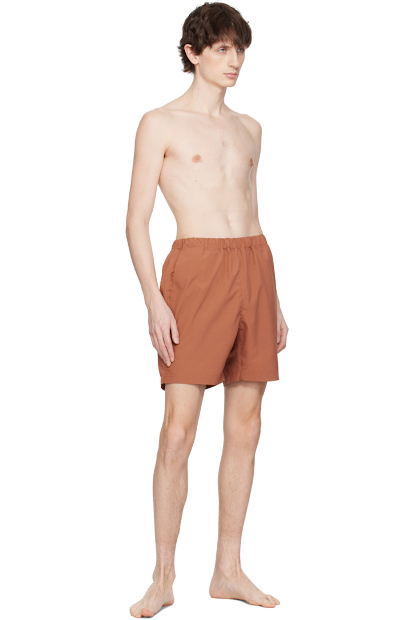 Taffeta swim shorts. 

· Concealed drawstring at elasticized waistband
· Three-pocket styling
· Logo patch at back waistband
· Partial mesh lining 

Supplier color: Brick