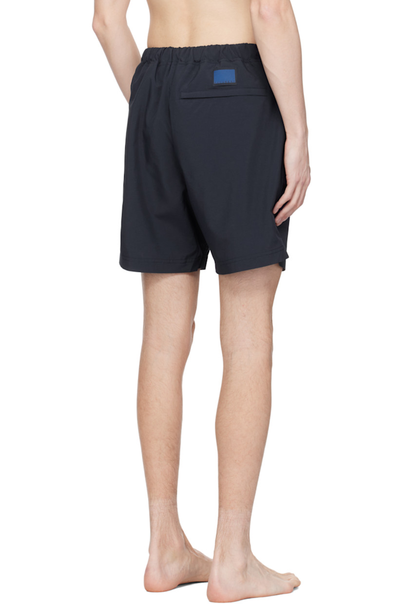Taffeta swim shorts. 

· Concealed drawstring at elasticized waistband
· Three-pocket styling
· Logo patch at back waistband
· Partial mesh lining 

Supplier color: Navy