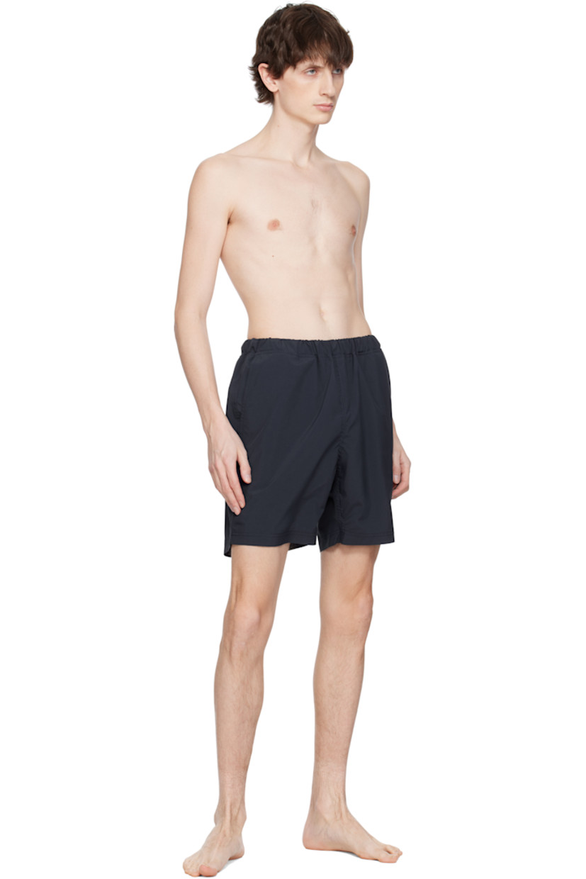 Taffeta swim shorts. 

· Concealed drawstring at elasticized waistband
· Three-pocket styling
· Logo patch at back waistband
· Partial mesh lining 

Supplier color: Navy