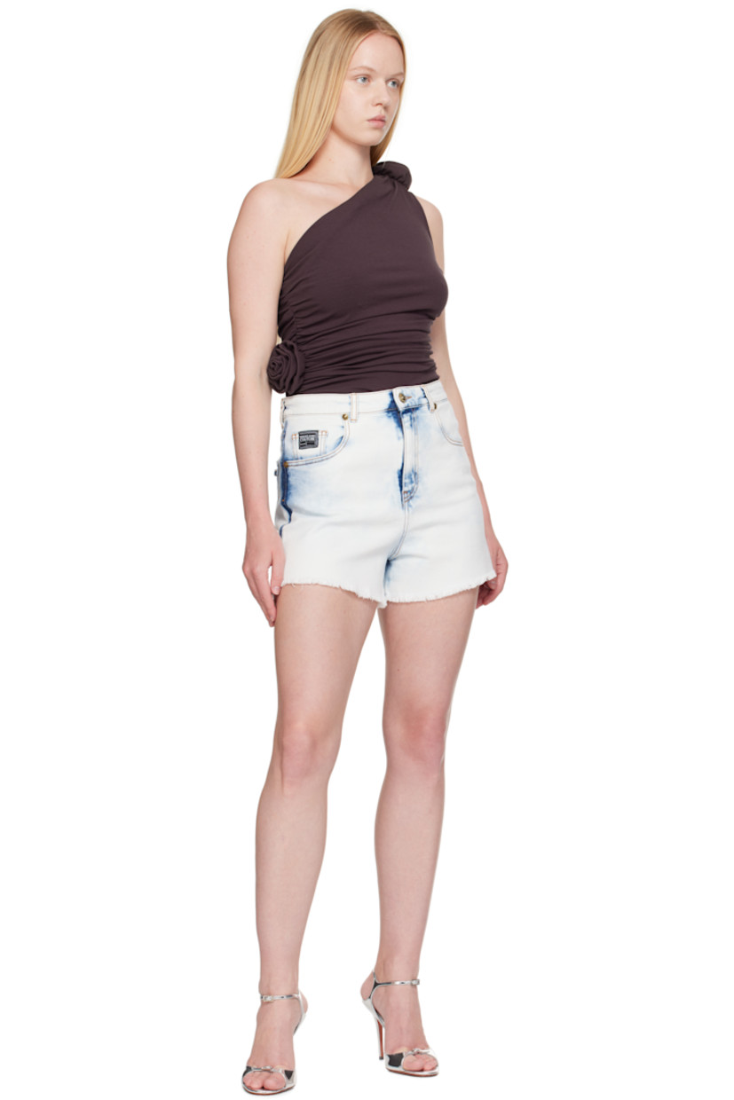 Non-stretch denim shorts.

· Fading throughout
· High-rise
· Belt loops
· Logo flag at coin pocket
· Five-pocket styling
· Zip fly
· Leather logo patch at back waistband
· Logo-engraved hardware at back pocket
· Contrast stitching in tan
· Gold-tone hardware

Supplier color: Indigo
