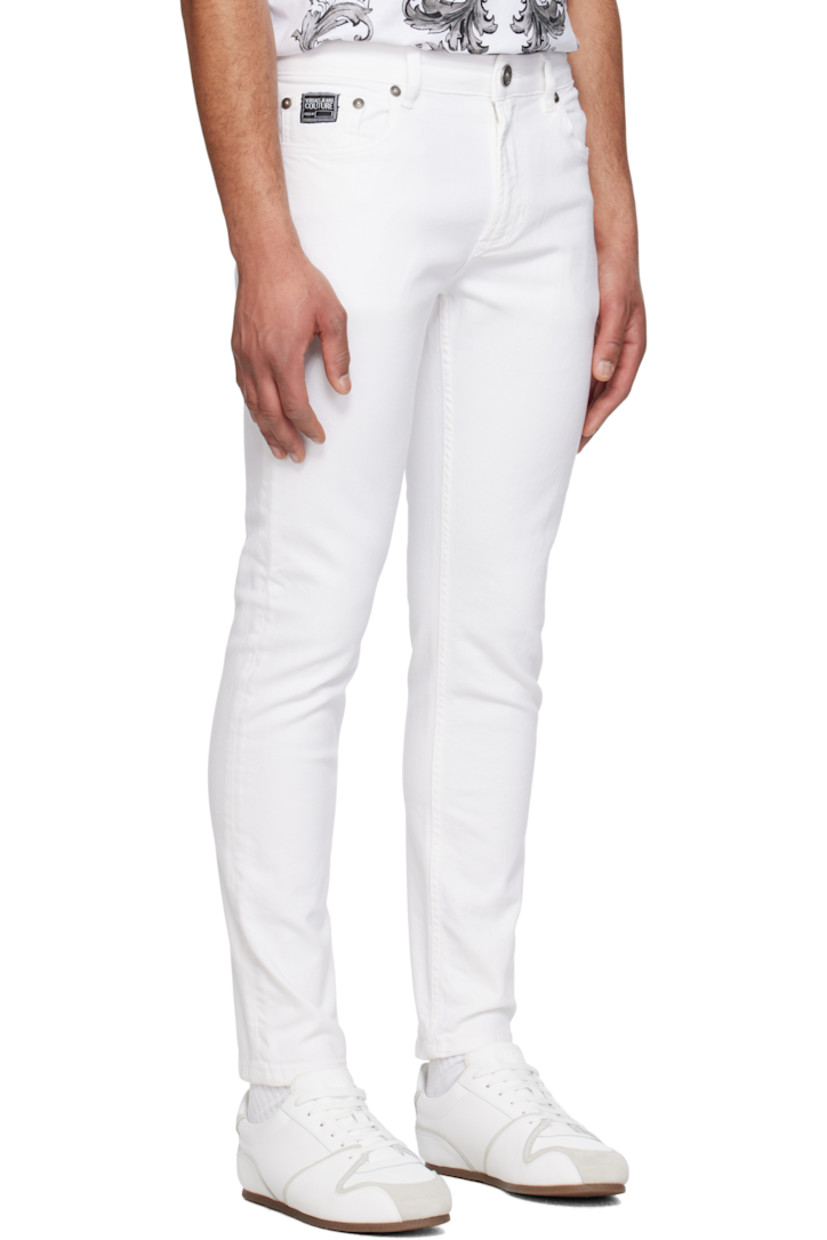 Stretch denim jeans. 

· Belt loops
· Five-pocket styling
· Zip fly
· Embroidered logo patch at coin pocket
· Leather logo patch at back waistband
· Logo-engraved silver-tone hardware

Supplier color: White