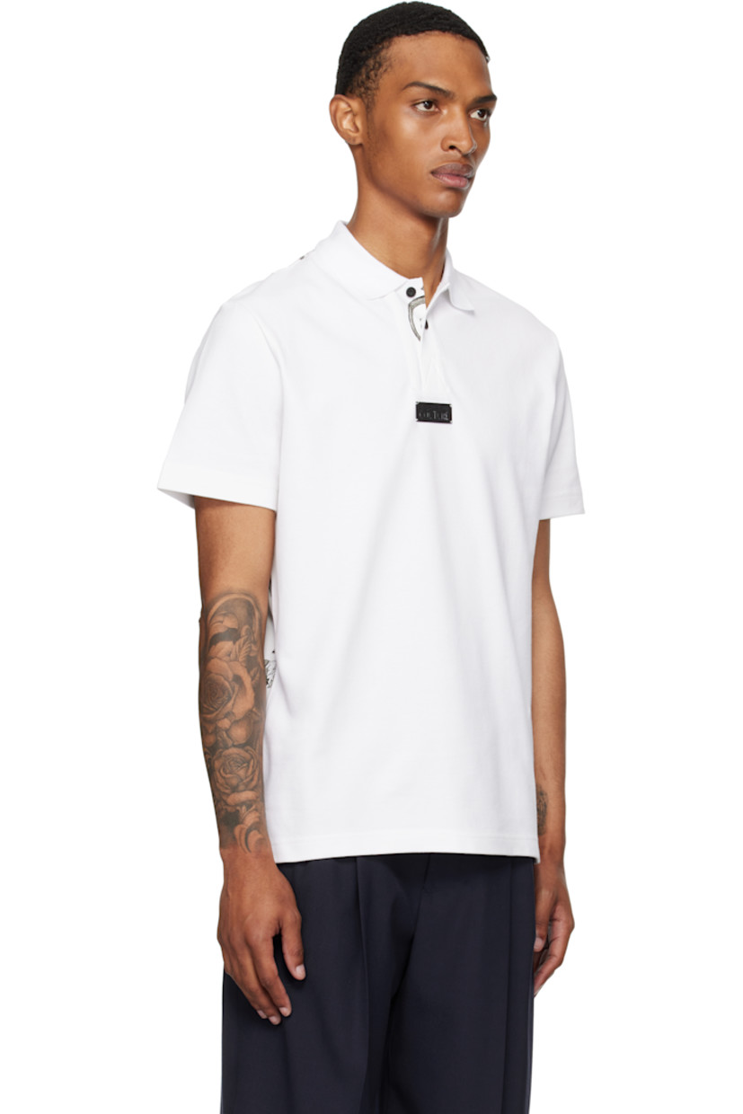 Cotton piqué polo.

· Rib-knit spread collar and cuffs
· Three-button placket
· Logo plaque at chest
· Barocco pattern printed at placket and back
· Tennis-tail hem

Supplier color: White/Print