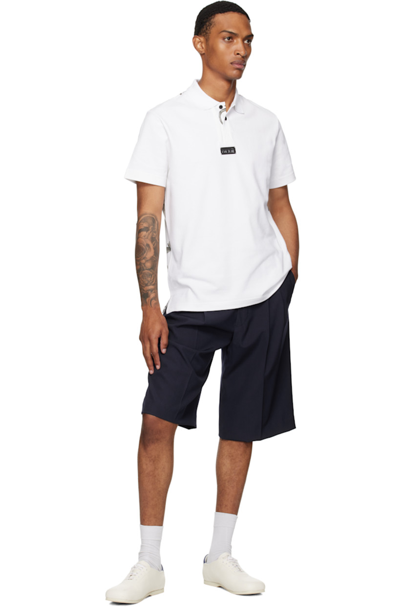 Cotton piqué polo.

· Rib-knit spread collar and cuffs
· Three-button placket
· Logo plaque at chest
· Barocco pattern printed at placket and back
· Tennis-tail hem

Supplier color: White/Print