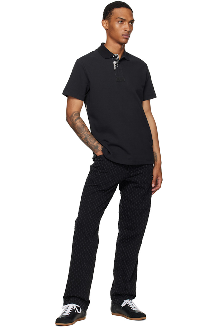 Cotton piqué polo.

· Rib-knit spread collar and cuffs
· Three-button placket
· Logo plaque at chest
· Barocco pattern printed at placket and back
· Tennis-tail hem

Supplier color: Black