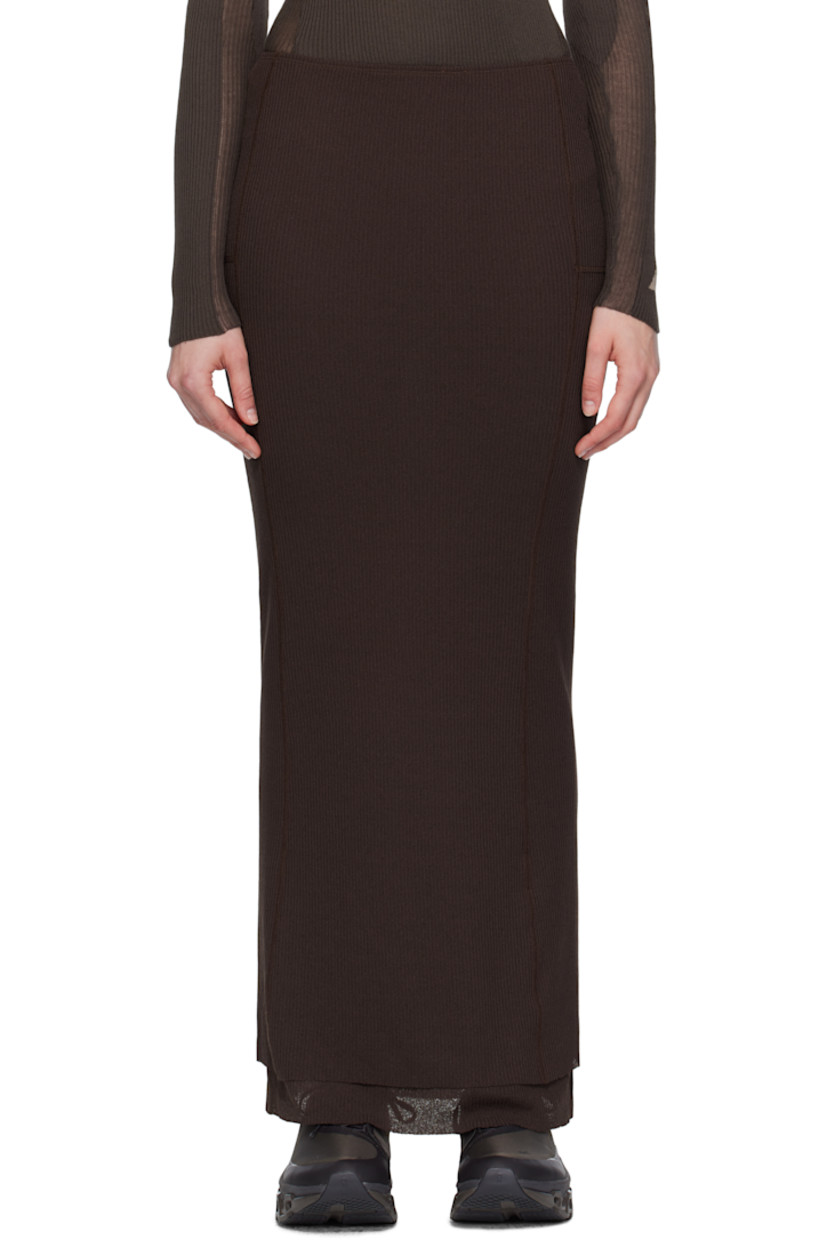 Polyester ribbed jersey sport skirt.

· Layered construction 
· Elasticized waistband
· Logo embroidered at waist
· Raw edges at tiered hem 
· Locker loops and shirring at back waist 

Supplier color: Dark brown