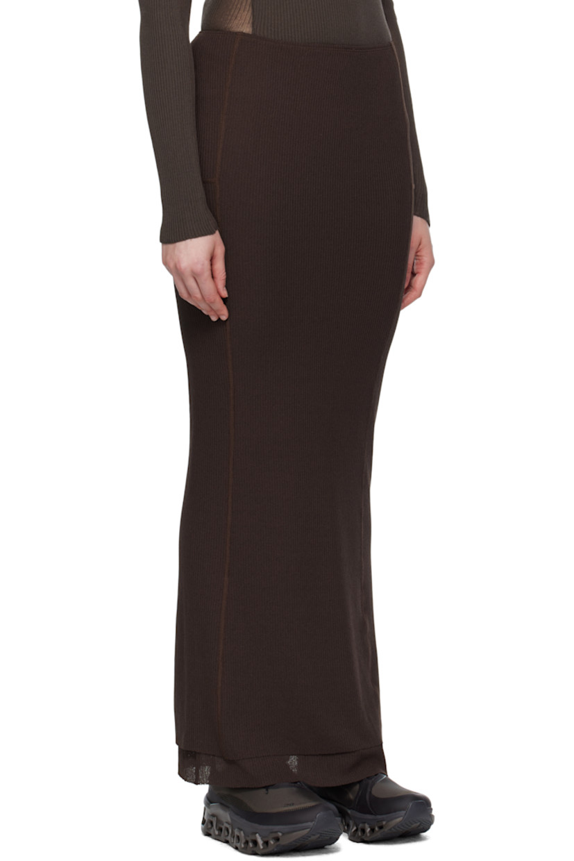 Polyester ribbed jersey sport skirt.

· Layered construction 
· Elasticized waistband
· Logo embroidered at waist
· Raw edges at tiered hem 
· Locker loops and shirring at back waist 

Supplier color: Dark brown