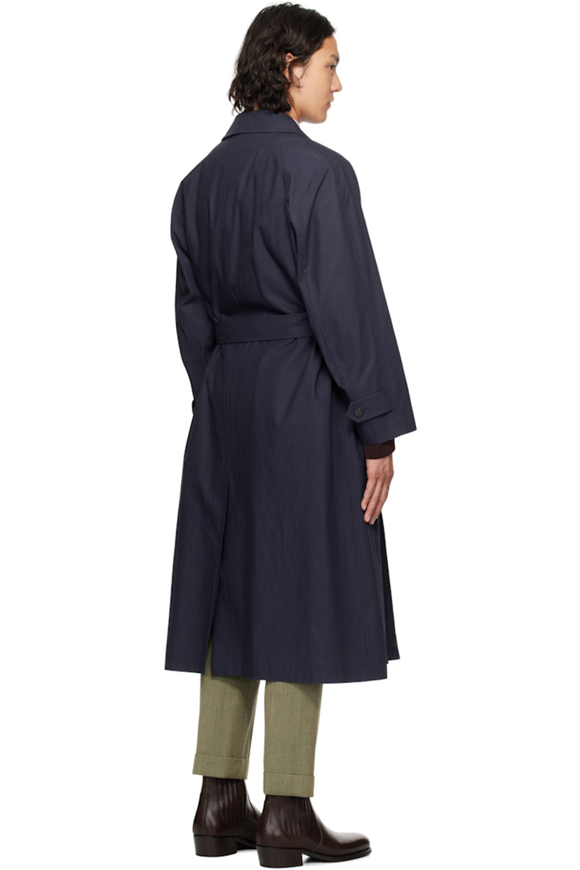 Cotton broadcloth trench coat. 

· Spread collar
· Double-breasted button closure
· Detachable pin-buckle belt 
· Welt pockets
· Raglan sleeves
· Adjustable button tab at cuffs
· Central vent at back hem
· Detachable padded and quilted cupro satin liner

Supplier color: Navy