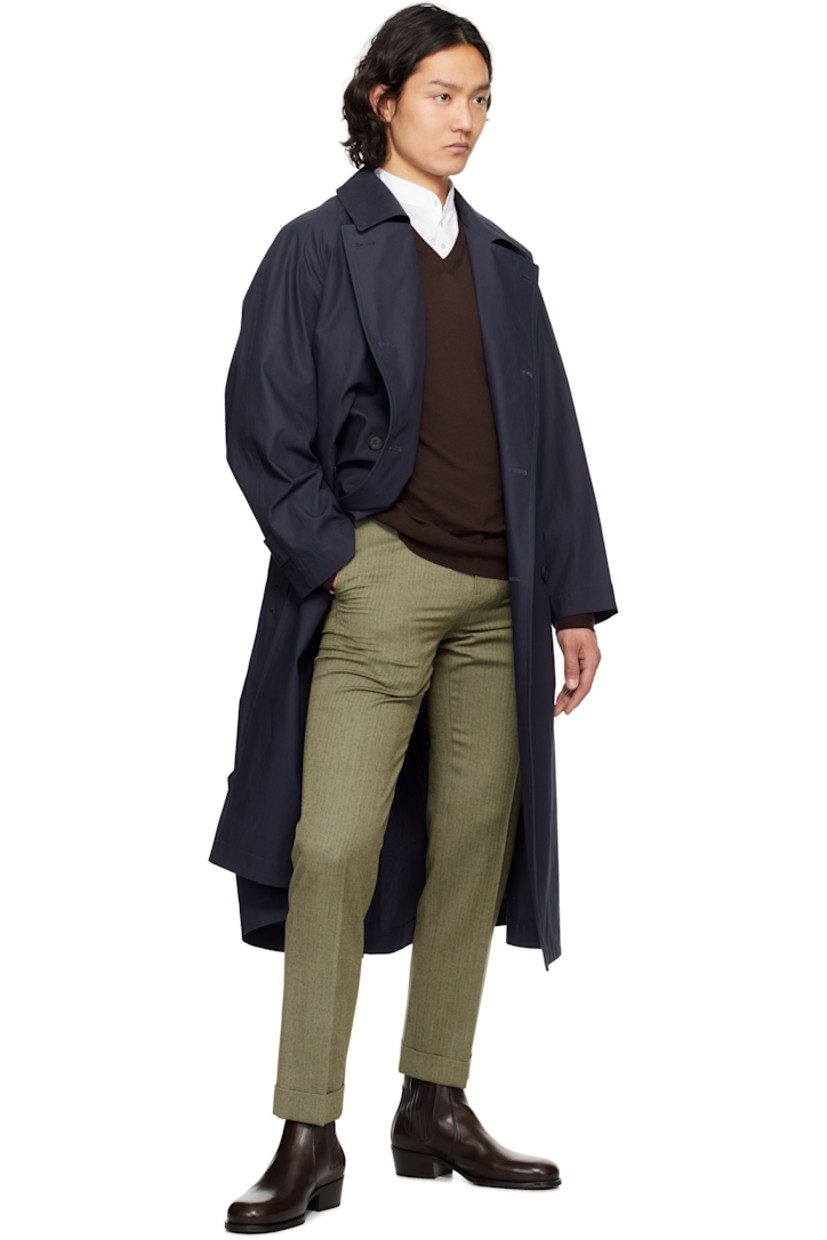 Cotton broadcloth trench coat. 

· Spread collar
· Double-breasted button closure
· Detachable pin-buckle belt 
· Welt pockets
· Raglan sleeves
· Adjustable button tab at cuffs
· Central vent at back hem
· Detachable padded and quilted cupro satin liner

Supplier color: Navy
