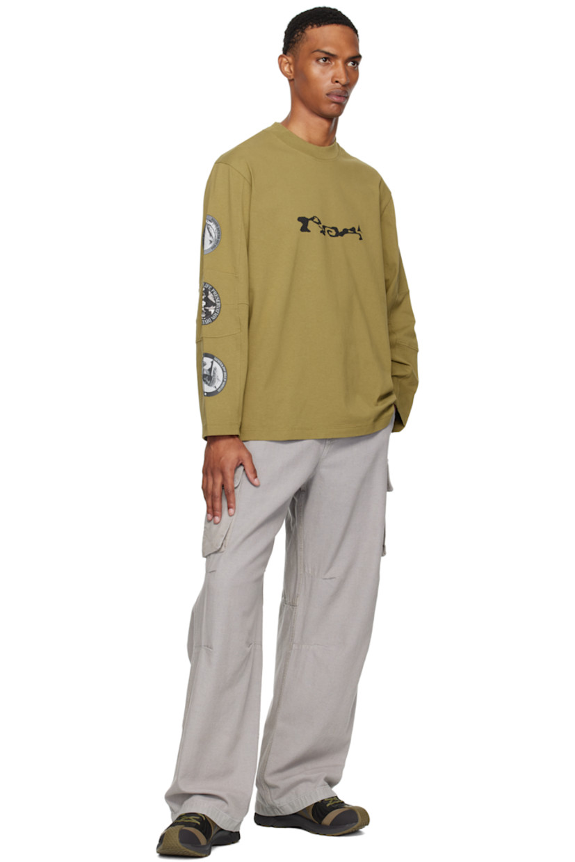 Heavyweight cotton jersey T-shirt.

· Rib-knit crewneck
· Logo printed at chest
· Paneled sleeves
· Printed graphics at sleeve
· Raised text and printed graphics at back

Supplier color: Olive drab