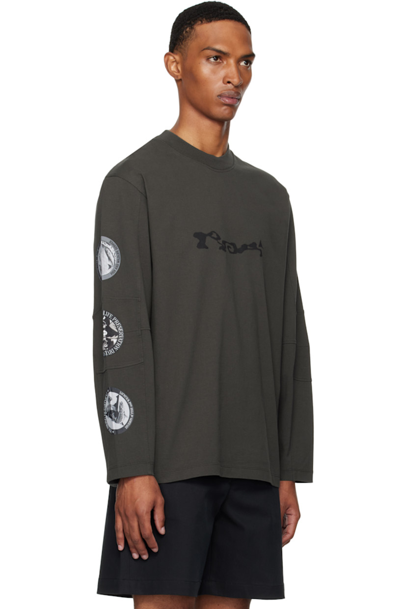 Heavyweight cotton jersey T-shirt.

· Rib-knit crewneck
· Logo printed at chest
· Paneled sleeves
· Printed graphics at sleeve
· Raised text and printed graphics at back

Supplier color: Black olive