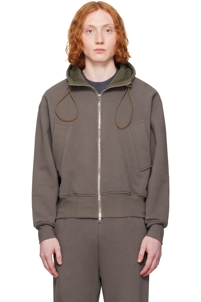 Heavyweight stretch French terry hoodie. 

· Bungee-style drawstring and jersey lining at hood
· Two-way zip closure
· Welt pockets
· Rib-knit hem and cuffs
· Dropped shoulders
· Thumbhole at cuffs
· Silver-tone hardware

Supplier color: Brown