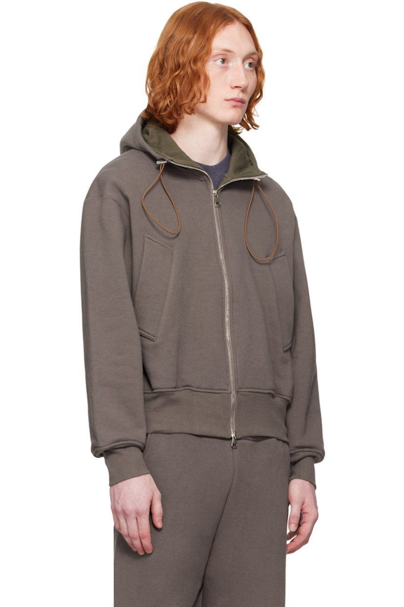 Heavyweight stretch French terry hoodie. 

· Bungee-style drawstring and jersey lining at hood
· Two-way zip closure
· Welt pockets
· Rib-knit hem and cuffs
· Dropped shoulders
· Thumbhole at cuffs
· Silver-tone hardware

Supplier color: Brown