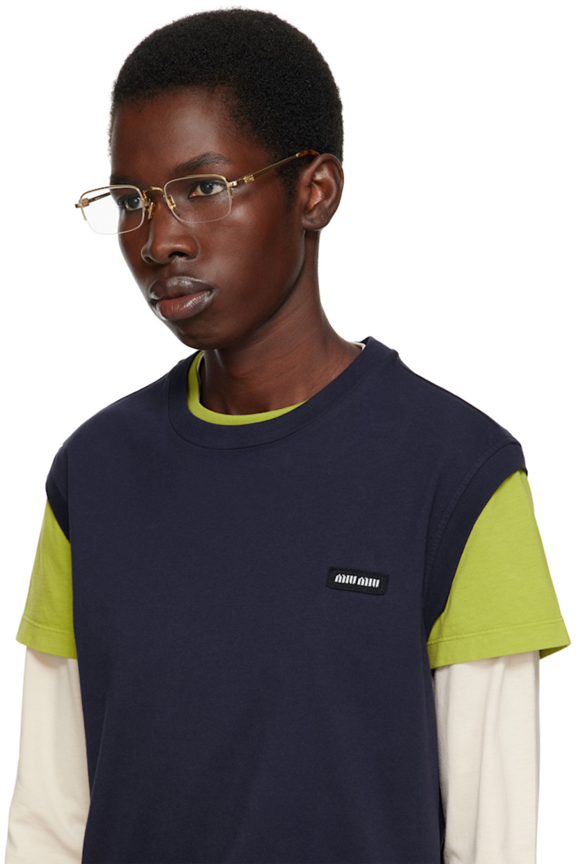 Rectangular semi-rimless metal-frame optical glasses in gold tone. 

· Adjustable rubber nose pads
· Logo hardware at temples
· Tortoiseshell acetate temple tips
· Includes case
· Size: 53.21 140 

Supplier color: Gold
