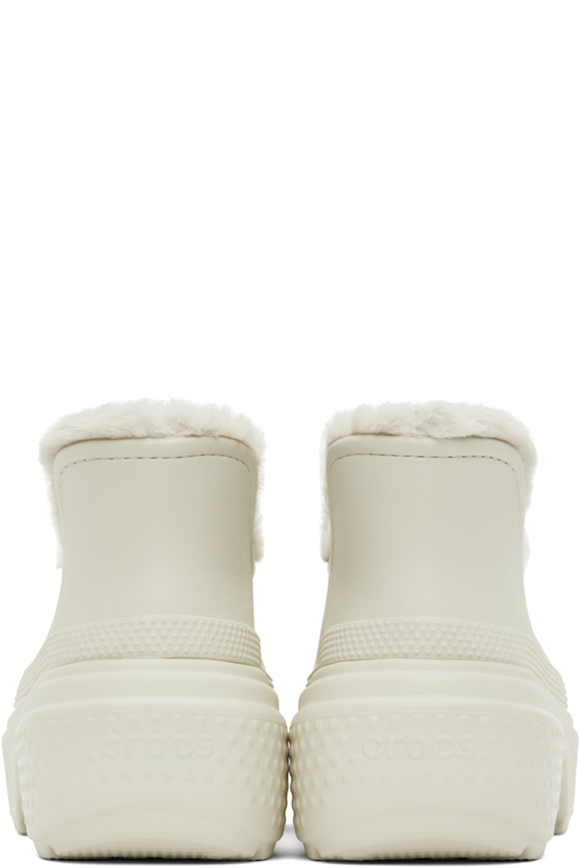 Ankle-high lightweight Croslite™ foam rubber boots in off-white.

· Perforated detailing at toe
· Dual Crocs Comfort™ molded footbed
· Faux-fur lining
· Logo embossed at rubber platform midsole
· Treaded rubber sole
· Platform: H2.5"

Part of the Stomp collection. 

Supplier color: Linen/Linen