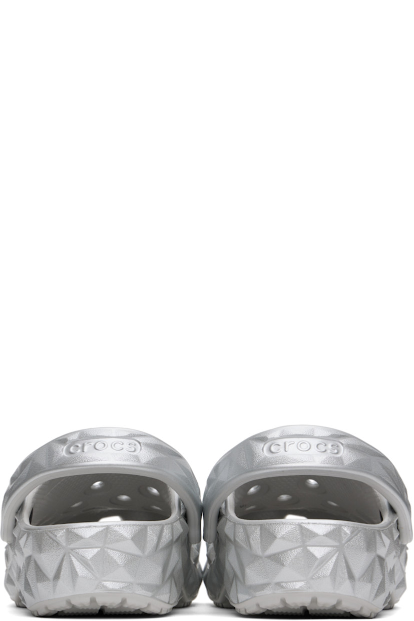 Lightweight sculptural Croslite™ foam rubber slip-on loafers in metallic silver tone. 

· Perforated detailing at vamp
· Logo embossed at convertible slingback strap
· Iconic Crocs Comfort™ molded rubber footbed
· Treaded rubber sole
· Logo-printed hardware

Supplier color: Silver