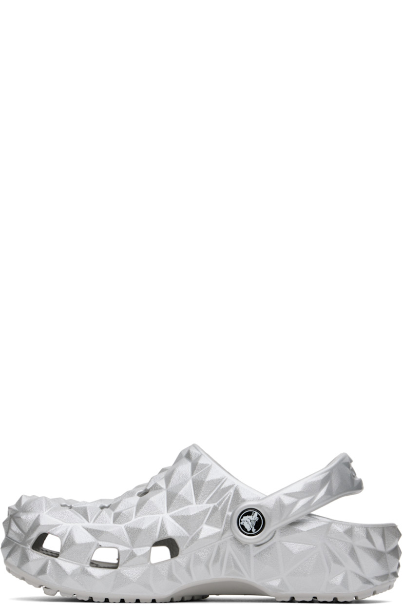Lightweight sculptural Croslite™ foam rubber slip-on loafers in metallic silver tone. 

· Perforated detailing at vamp
· Logo embossed at convertible slingback strap
· Iconic Crocs Comfort™ molded rubber footbed
· Treaded rubber sole
· Logo-printed hardware

Supplier color: Silver