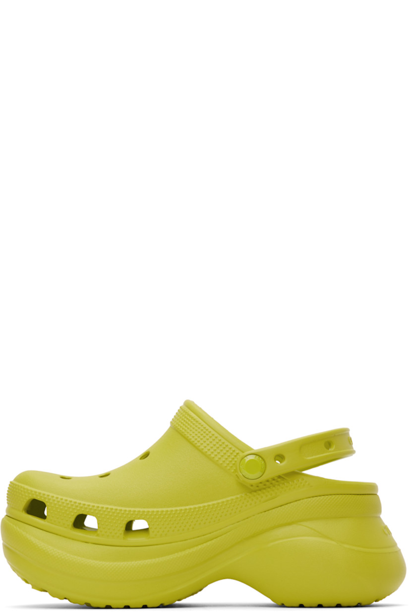 Rubber slip-on loafers in green.

· Perforated detailing throughout
· Logo-embossed convertible slingback strap
· Logo embossed at heel
· Molded rubber footbed
· Sculptural rubber platform midsole
· Treaded rubber sole
· Logo-engraved hardware
· Platform: H3"

Supplier color: Kiwi
