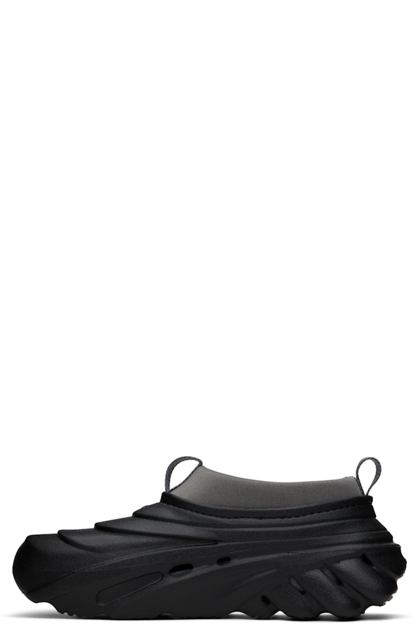 Sculptural rubber slip-on loafers in black.

· Cutouts throughout
· Logo embossed at vamp and heel counter
· Pull-loops at padded jersey collar
· LiteRide™ molded rubber footbed
· Bonded jersey lining
· Treaded rubber sole

Supplier color: Midnight