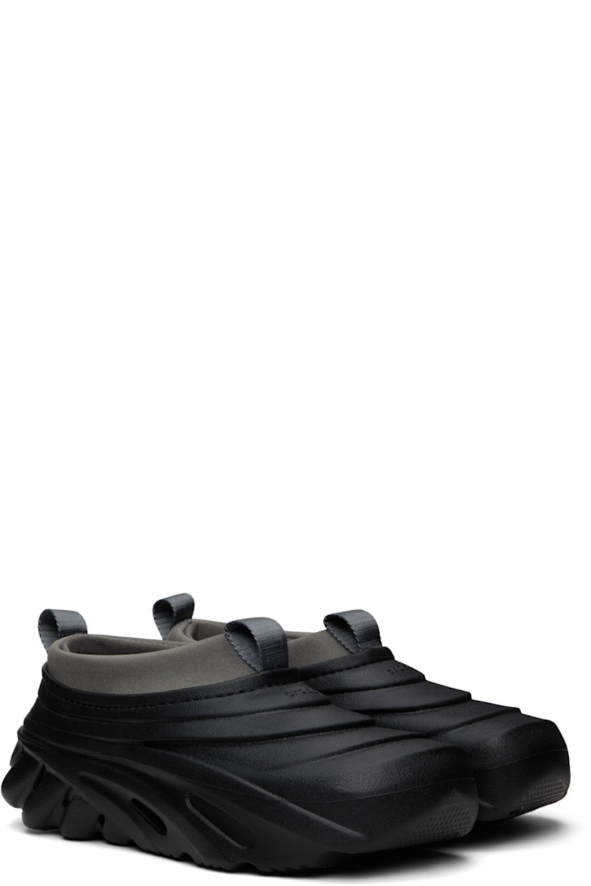 Sculptural rubber slip-on loafers in black.

· Cutouts throughout
· Logo embossed at vamp and heel counter
· Pull-loops at padded jersey collar
· LiteRide™ molded rubber footbed
· Bonded jersey lining
· Treaded rubber sole

Supplier color: Midnight