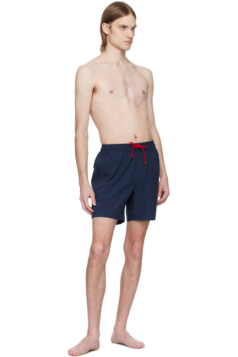 Stretch recycled polyester taffeta swim shorts.

· Drawstring at elasticized waistband
· Three-pocket styling
· Logo bonded at leg
· Logo patch and grommet at back pocket
· Brief-style mesh lining

Supplier color: Newport navy