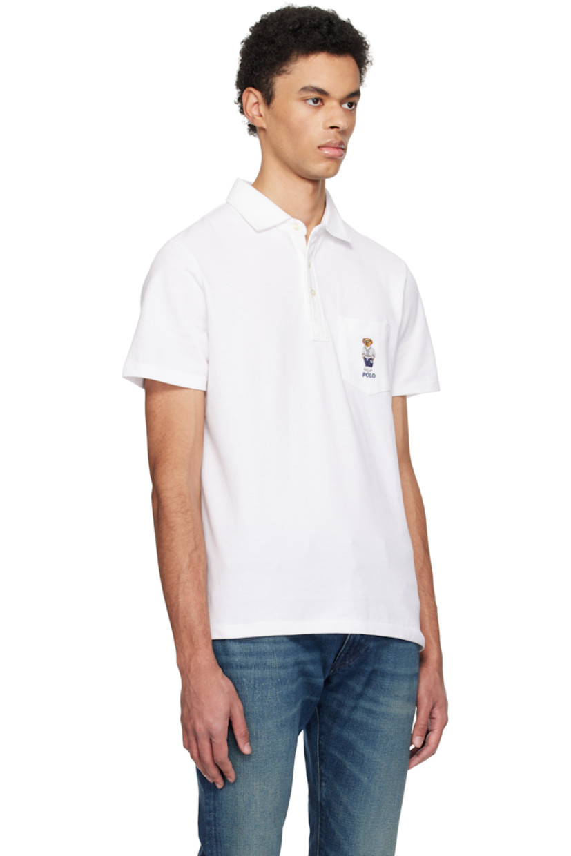 Breathable cotton piqué polo.

· Spread collar 
· Three-button placket
· Logo graphic embroidered at patch pocket
· Tennis-tail hem

Supplier color: White heritage icons