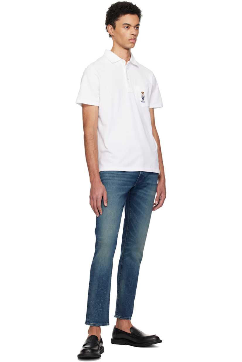 Breathable cotton piqué polo.

· Spread collar 
· Three-button placket
· Logo graphic embroidered at patch pocket
· Tennis-tail hem

Supplier color: White heritage icons