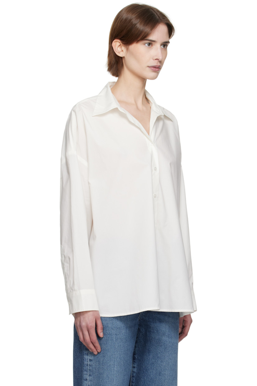Lightweight cotton poplin shirt. 

· Oversized
· Spread collar
· Button closure
· Droptail hem
· Pleats at single-button barrel cuffs
· Darts at back hem

Supplier color: Rice