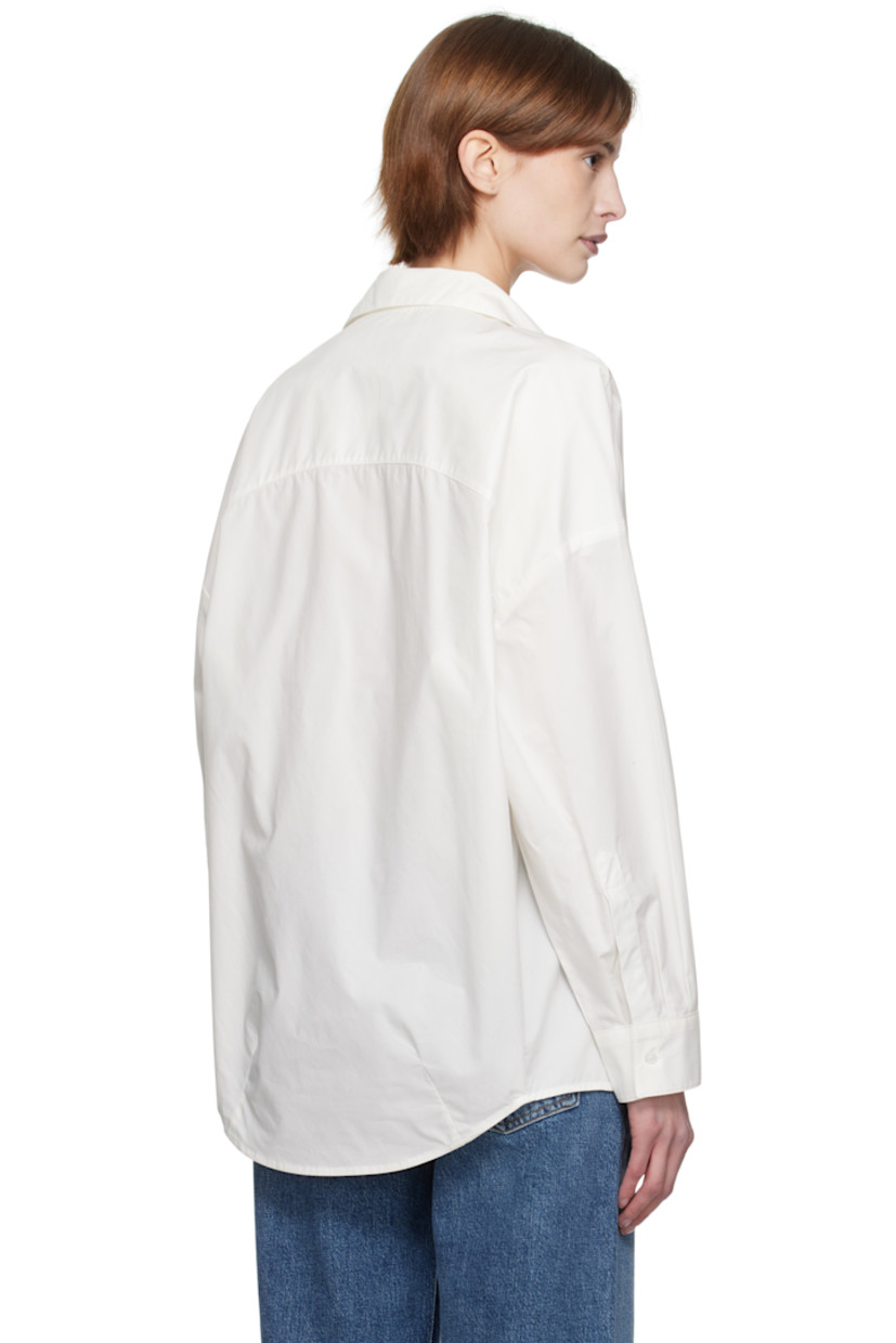 Lightweight cotton poplin shirt. 

· Oversized
· Spread collar
· Button closure
· Droptail hem
· Pleats at single-button barrel cuffs
· Darts at back hem

Supplier color: Rice