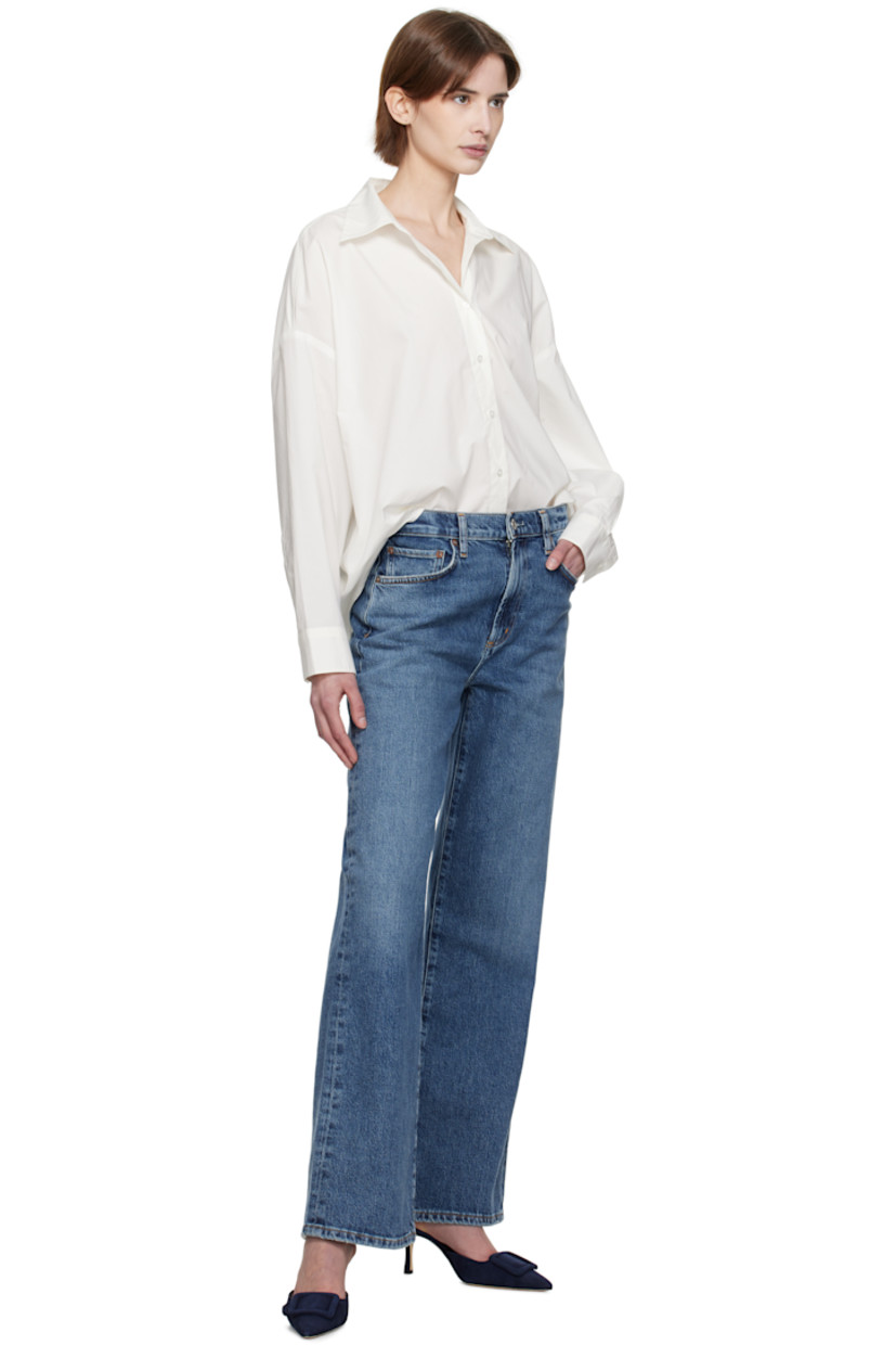 Lightweight cotton poplin shirt. 

· Oversized
· Spread collar
· Button closure
· Droptail hem
· Pleats at single-button barrel cuffs
· Darts at back hem

Supplier color: Rice