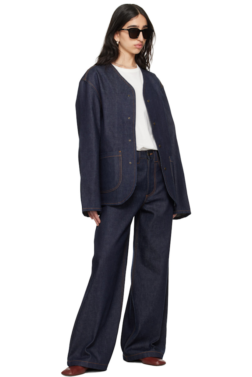 Non-stretch organic cotton denim jacket. 

· Y-neck 
· Press-stud closure 
· Patch pockets 
· Central vent at back hem 
· Patch pocket and logo patch at interior 
· Contrast stitching in tan 

Supplier color: Midnight blue