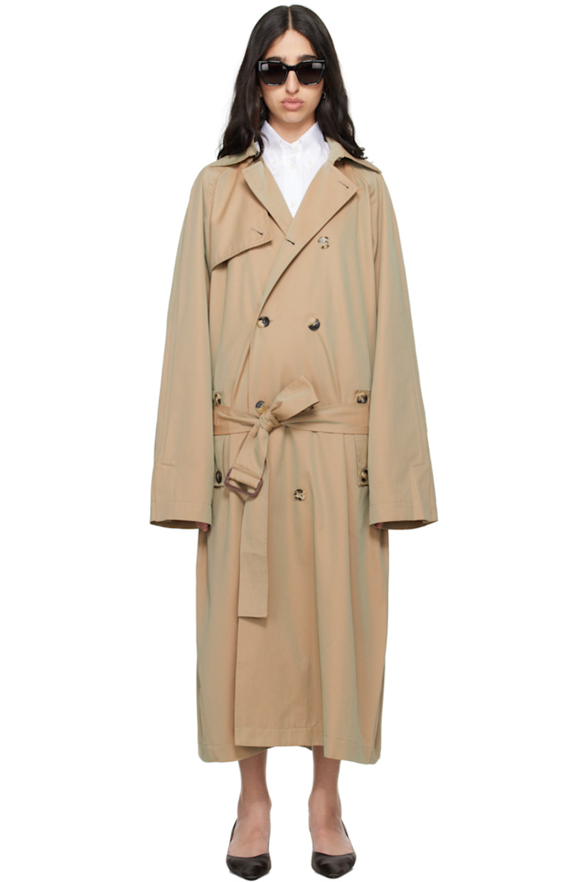 Organic cotton gabardine trench coat.

· Hook-eye fastening at spread collar
· Double-breasted button closure
· Storm flap at front and back
· Belt loops and detachable cinch belt
· Flap pockets
· Raglan sleeves
· Vented cuffs
· Logo embroidered at cuff
· Inverted box pleat at back hem
· Unlined

Supplier color: Beige