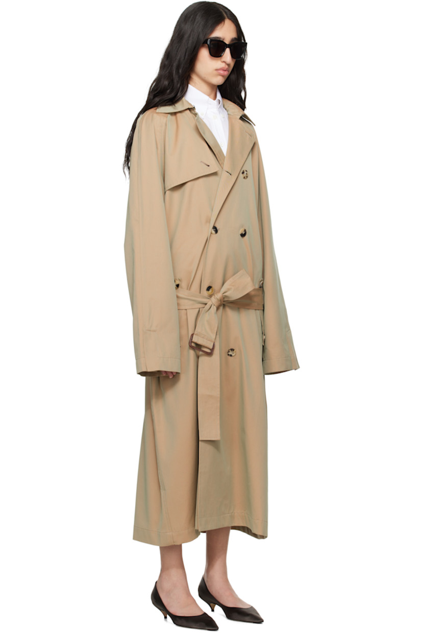 Organic cotton gabardine trench coat.

· Hook-eye fastening at spread collar
· Double-breasted button closure
· Storm flap at front and back
· Belt loops and detachable cinch belt
· Flap pockets
· Raglan sleeves
· Vented cuffs
· Logo embroidered at cuff
· Inverted box pleat at back hem
· Unlined

Supplier color: Beige