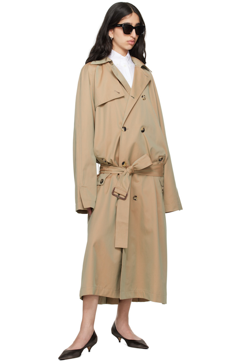Organic cotton gabardine trench coat.

· Hook-eye fastening at spread collar
· Double-breasted button closure
· Storm flap at front and back
· Belt loops and detachable cinch belt
· Flap pockets
· Raglan sleeves
· Vented cuffs
· Logo embroidered at cuff
· Inverted box pleat at back hem
· Unlined

Supplier color: Beige