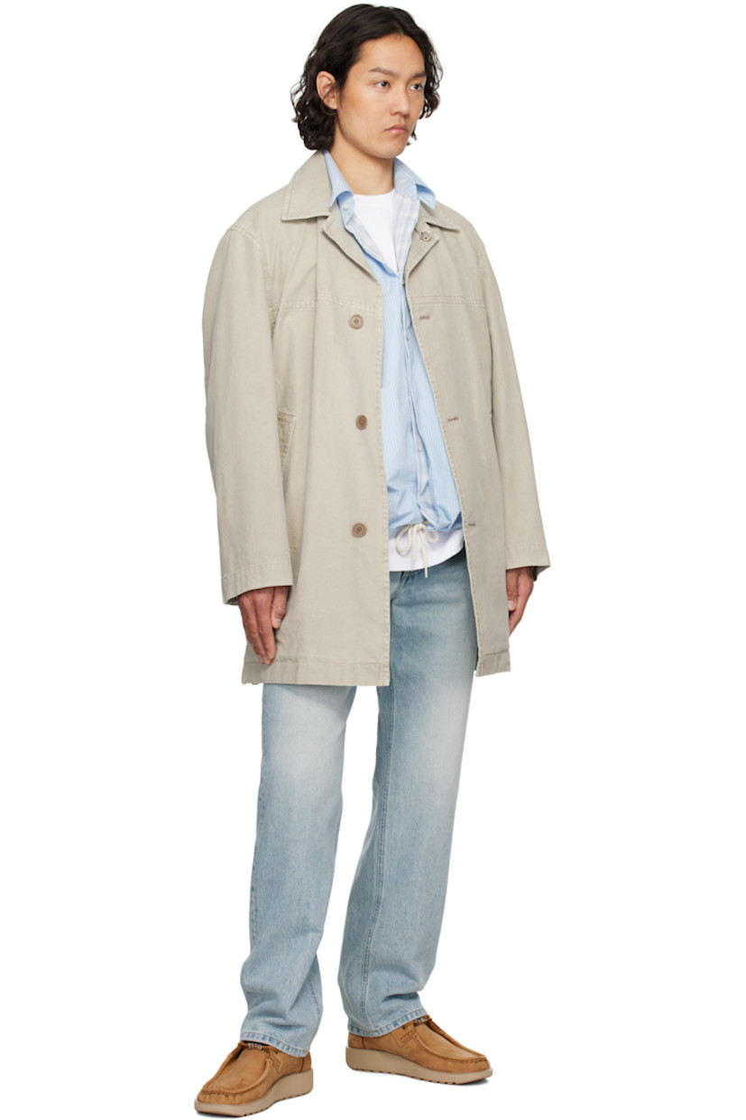 Cotton canvas coat.

· Detachable logo hardware at open spread collar
· Button closure
· Welt pockets
· Buttoned vent at side seams
· Dropped shoulders
· Adjustable button tab at cuffs
· Patch pockets at interior
· Partial cotton twill lining

Supplier color: Khaki