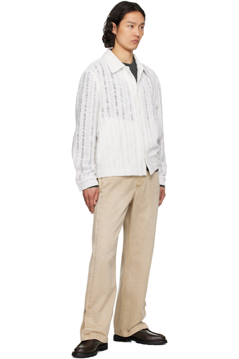 Crocheted cotton-blend jacket. Laddering throughout. 

· Spread collar
· Button closure
· Welt pockets
· Vented side seams
· Single-button barrel cuffs

Supplier color: White
