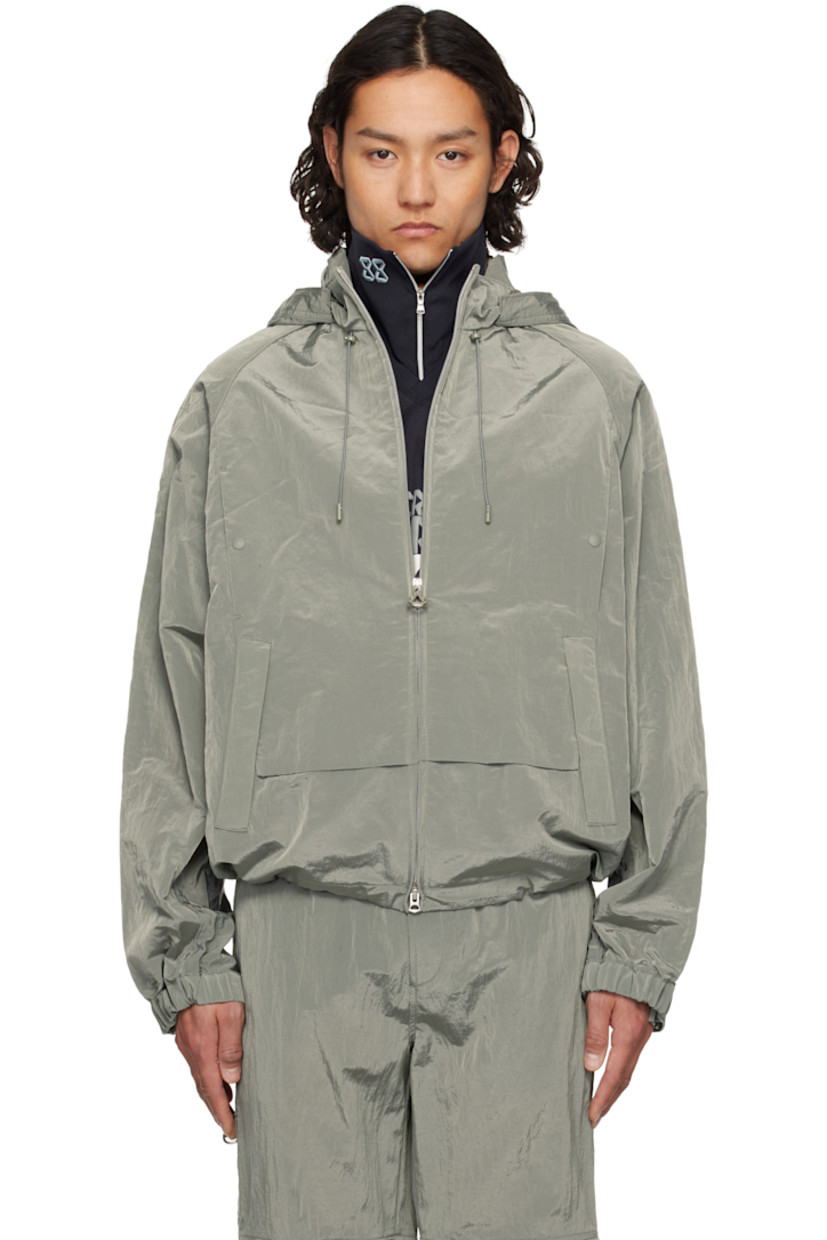 Crinkled nylon taffeta jacket.

· Bungee-style drawstring at stowaway hood 
· Stand collar
· Two-way zip closure
· Welt pockets and zip pockets
· Storm flap at front and back
· Concealed drawstring at hem
· Two-way zip vent at raglan sleeves
· Adjustable press-stud tab at elasticized cuffs
· Partial mesh lining
· Logo-engraved silver-tone hardware

Supplier color: Khaki