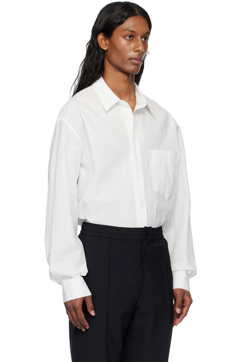 Cotton poplin shirt.

· Spread collar
· Button closure
· Patch pocket
· Shirttail hem
· Buttoned barrel cuffs
· Logo appliqué at back

Supplier color: White