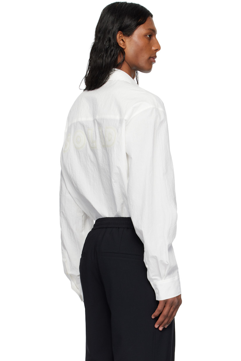 Cotton poplin shirt.

· Spread collar
· Button closure
· Patch pocket
· Shirttail hem
· Buttoned barrel cuffs
· Logo appliqué at back

Supplier color: White